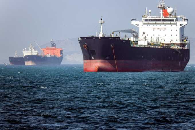 U.S. commercial ships cross Strait of Hormuz under armed escort as Iran launches missile and drone attacks